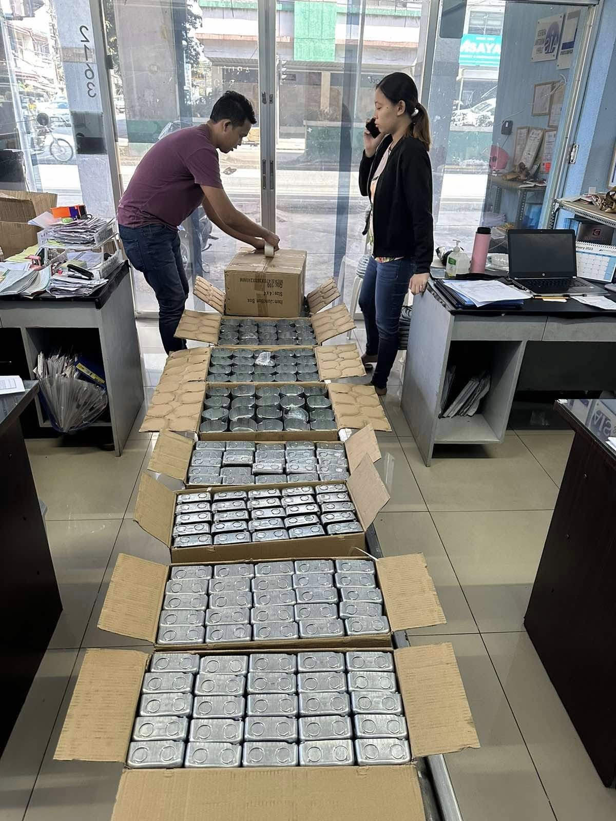 Arditech staff counting and packing rows of electrical junction boxes for a customer order
