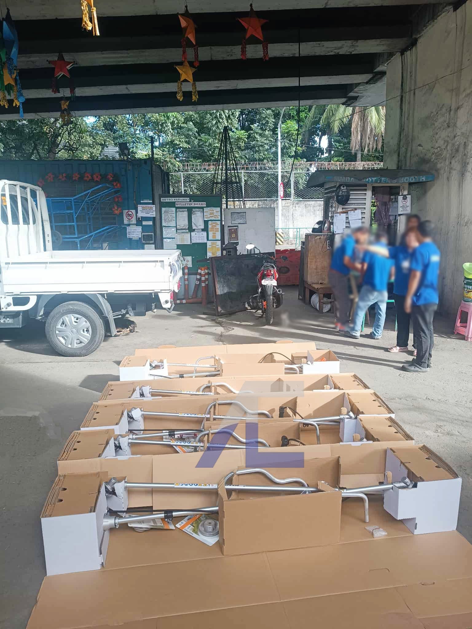 Arditech staff preparing a bulk order of industrial products for dispatch at the loading dock beside a delivery truck