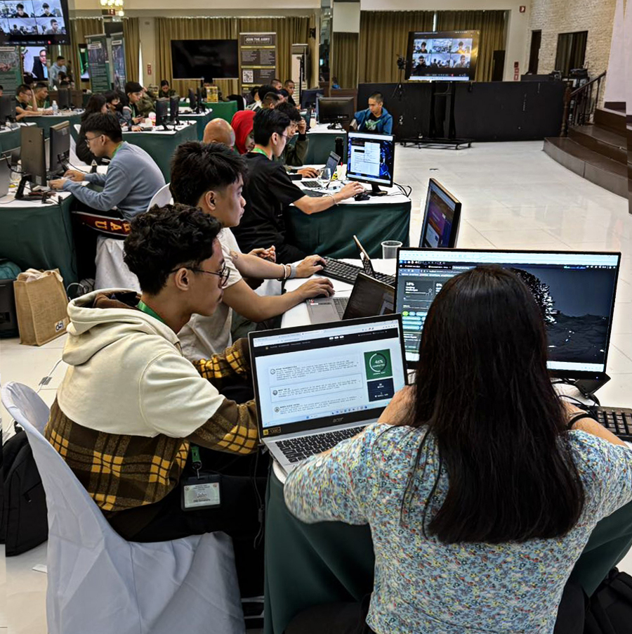 AMA University students working hands-on at computers during a live cyber defense exercise
