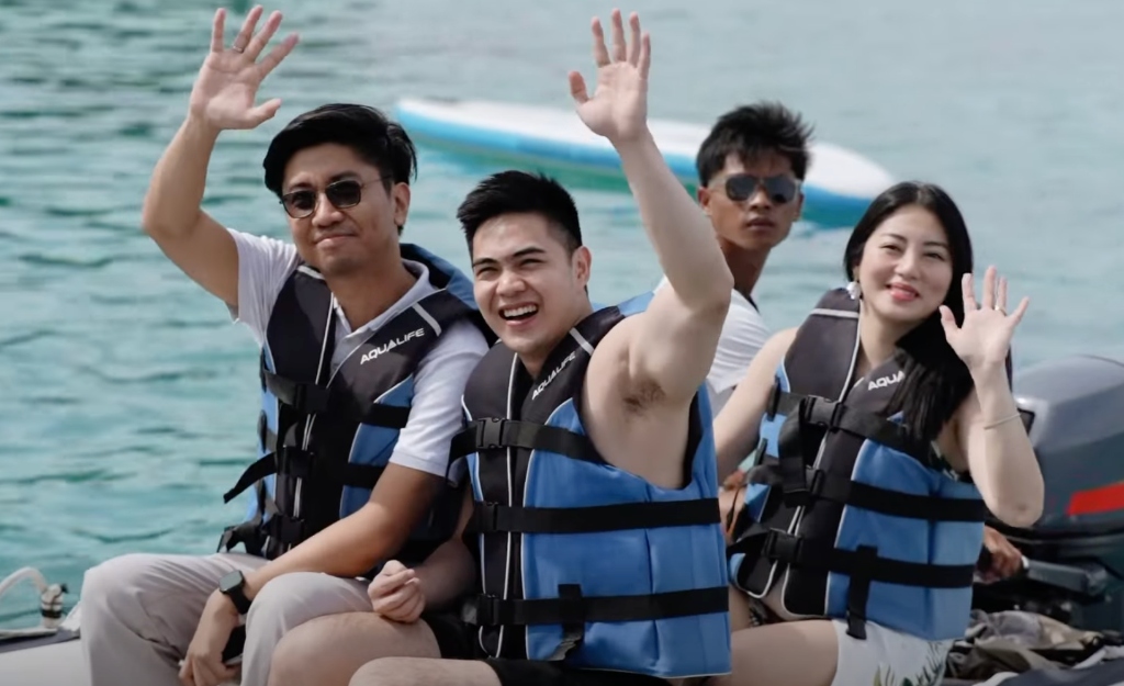 GCI entrepreneurs waving from a boat during the Talicud Island fellowship experience