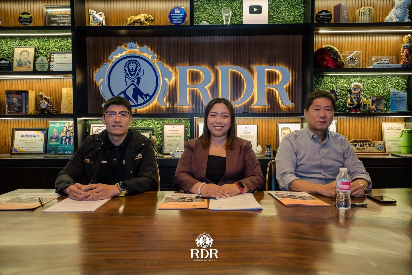 Ms. Mary Rose Deocareza, RDR Group Sales Director, with the two Nova Prime owners during the partnership signing