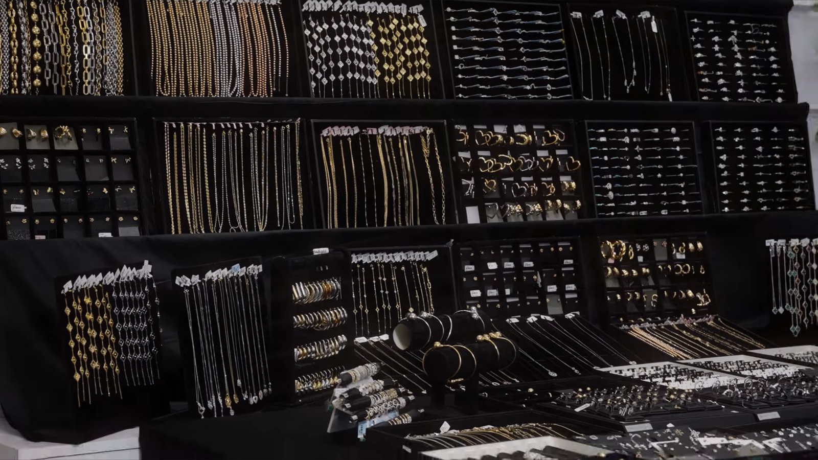 Wall of gold and silver chains, rings and earrings at the source warehouse