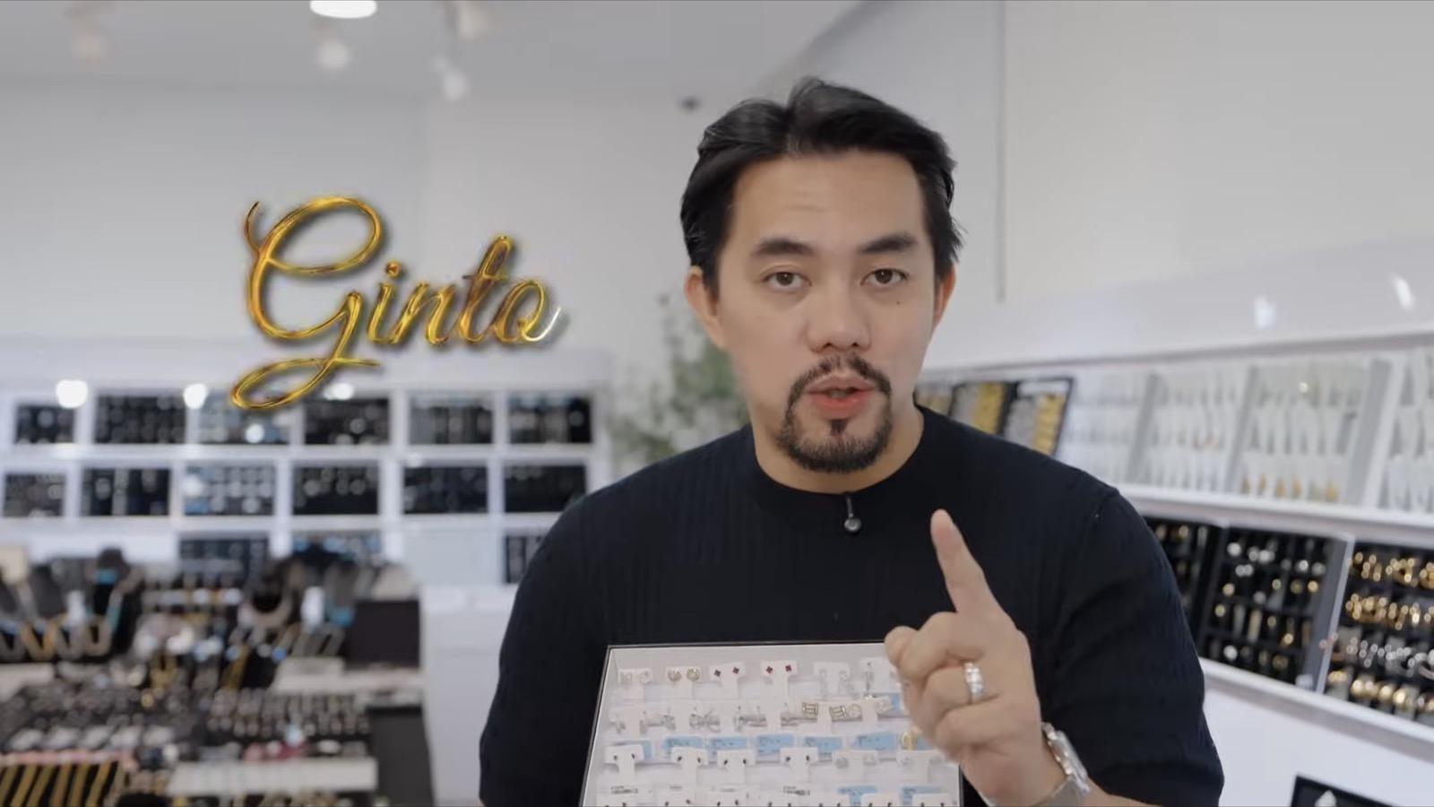 Inside the Ginto jewelry source store with the host presenting pieces